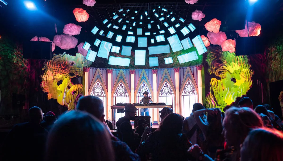 Meow Wolf Denverの展示空間で照明と音楽を楽しむ来場者