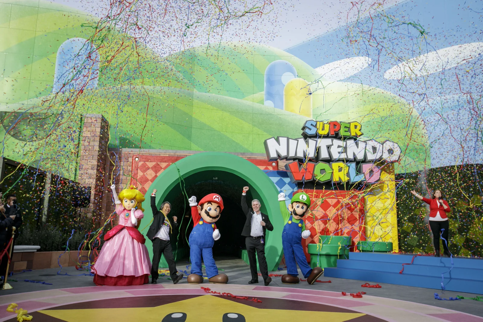 SUPER NINTENDO WORLDの開業式に登壇したマリオ、ルイージ、ピーチ姫と関係者